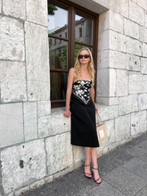 a lady wearing a silk scarf as a top with black midi dress